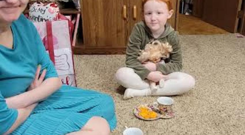 two people having tea party on the floor