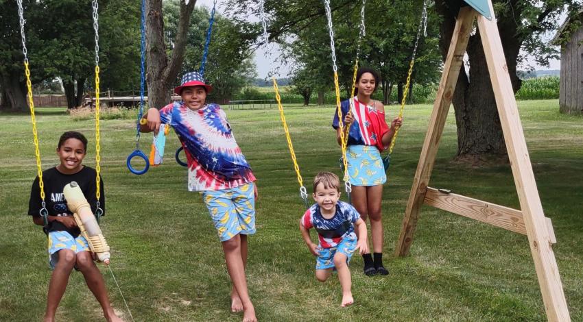 four kids on swings