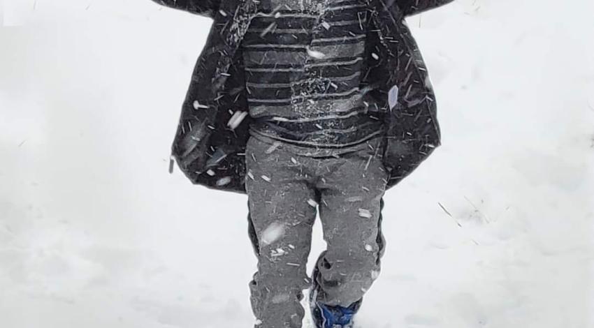 boy walking in snow