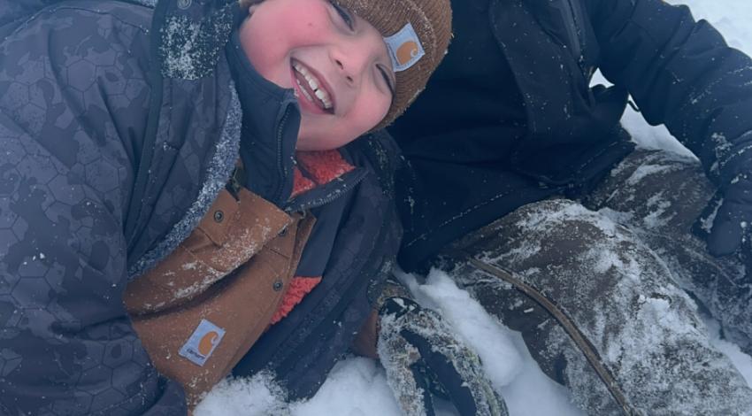two smiling boys in snow