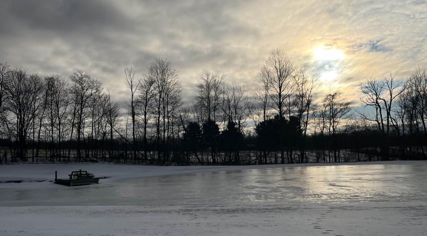 frozen pond in front of sunrise