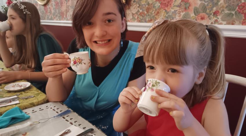 two girls drinking tea
