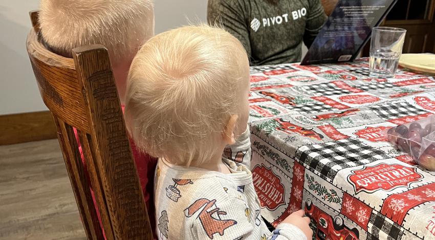 man reading to two children 