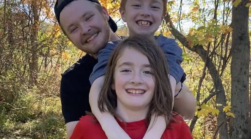 three boys in autumn forest