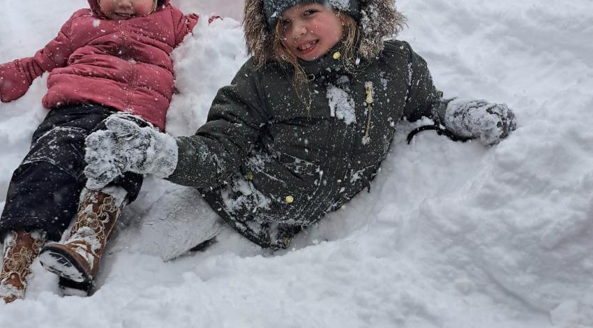two smiling girls in the snow
