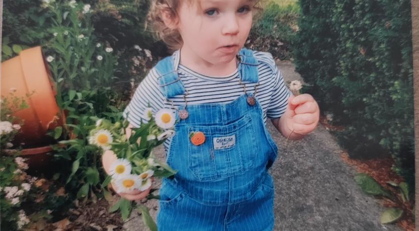 little girl holding flowers
