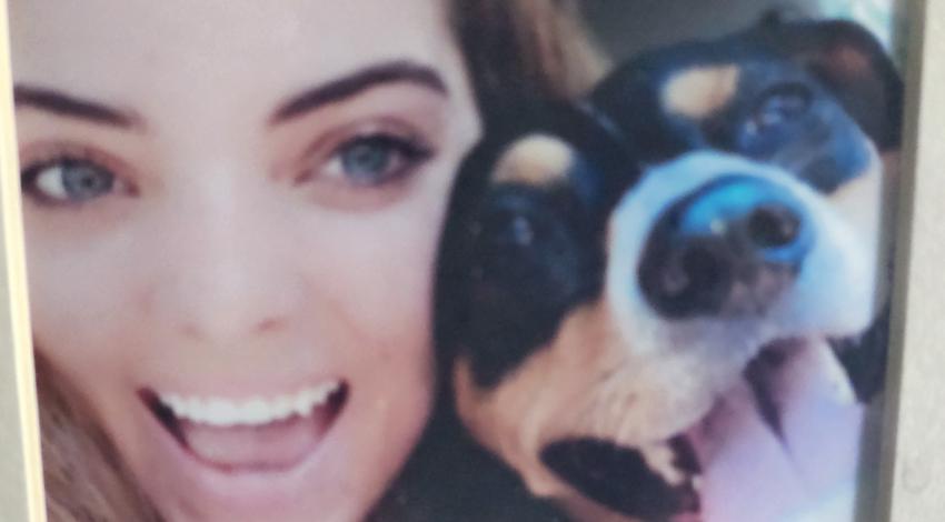 young woman and dog, both smiling