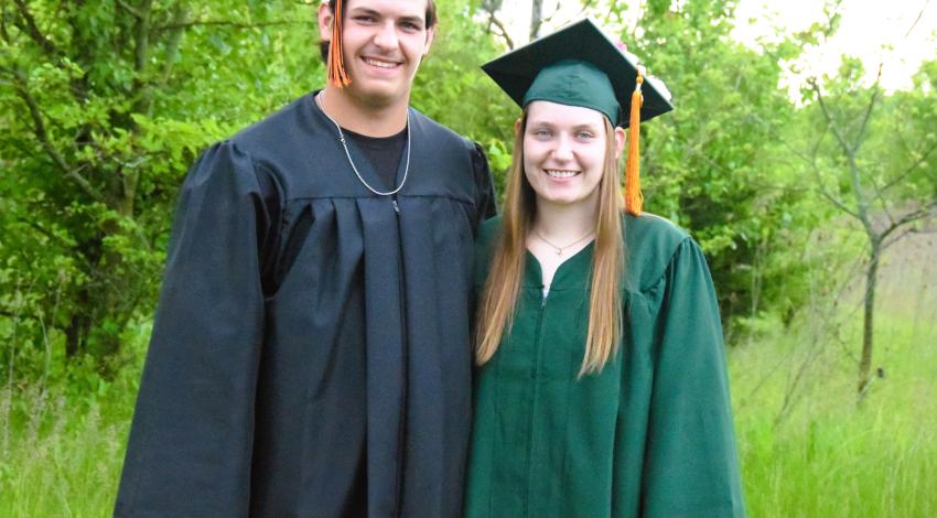 young man and young woman in caps and gowns