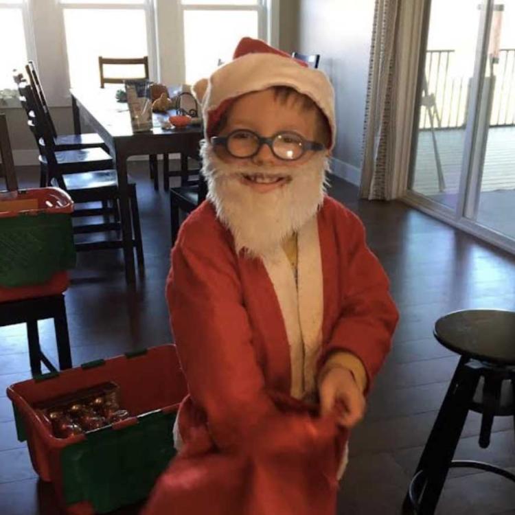 smiling little boy in Santa suit