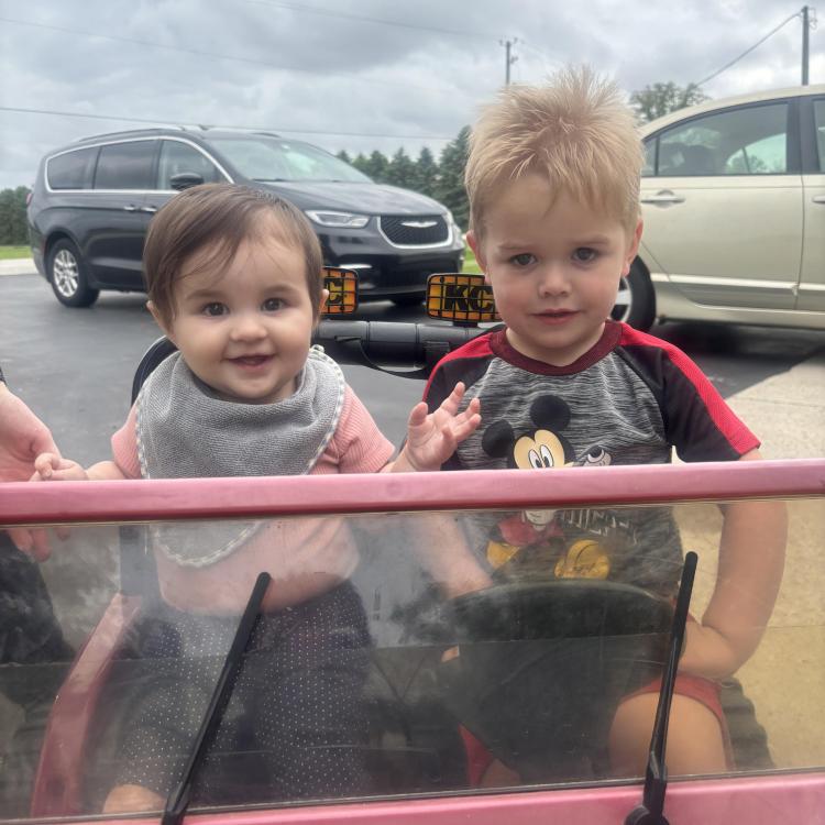 two small children in toy Jeep