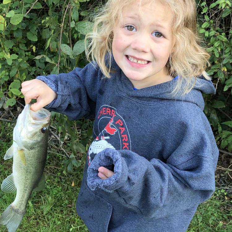 smiling girl holding a fish