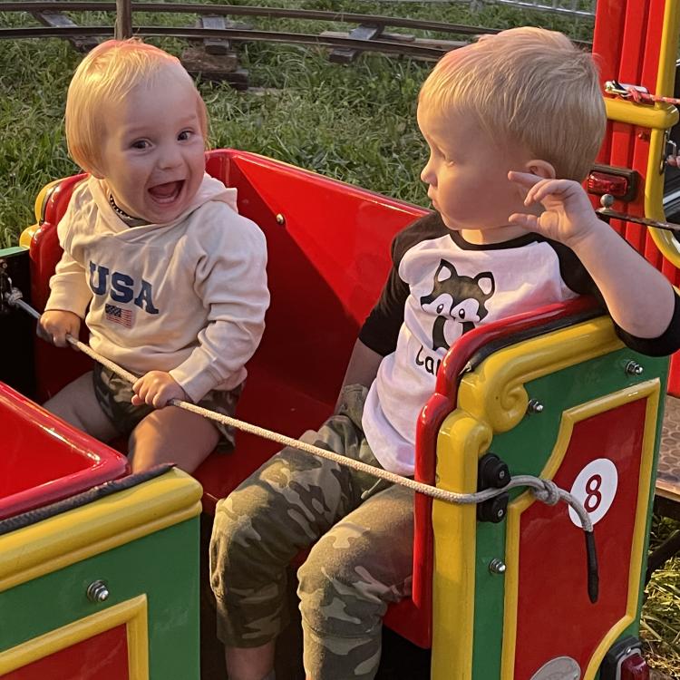 two little boys on kids' coaster