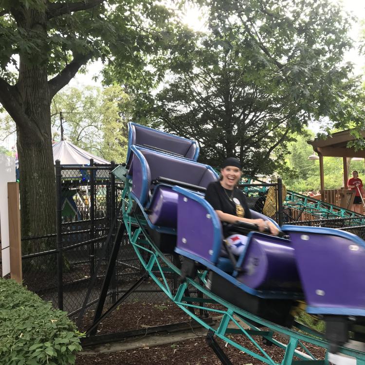 Adult and child on purple roller coaster