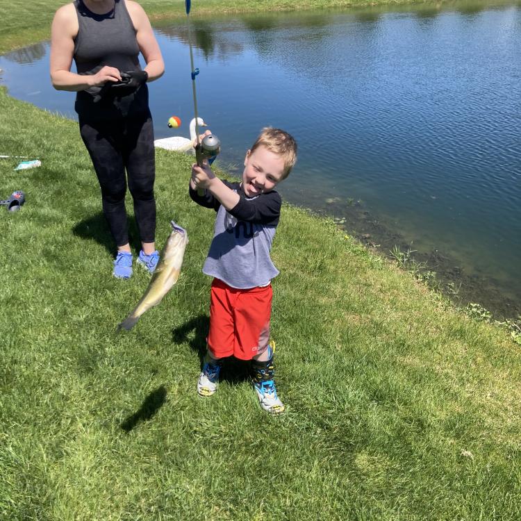 Little boy holding a fish