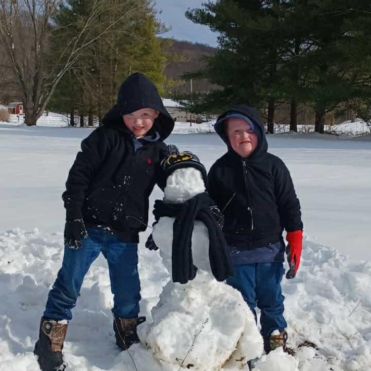 two kids with snowman