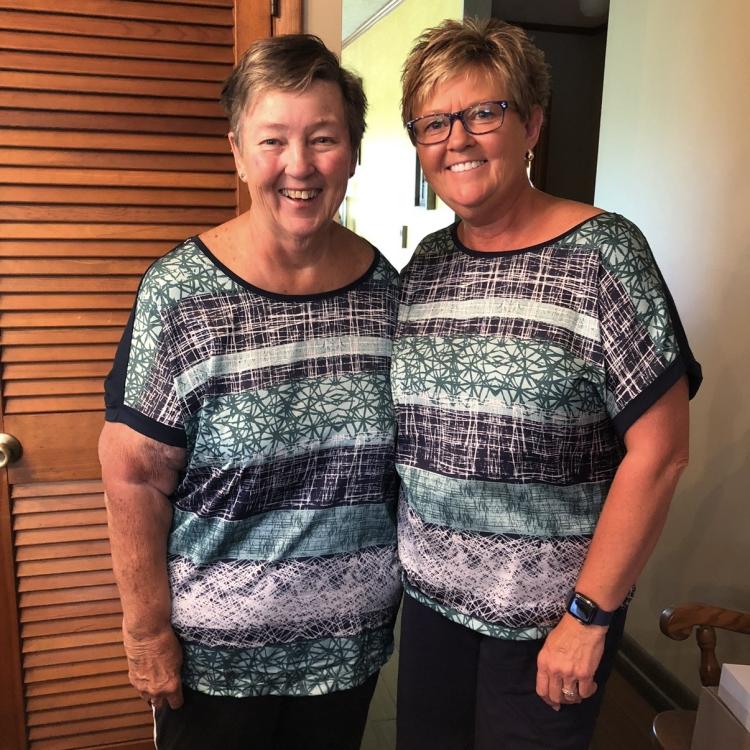 two women in matching shirts