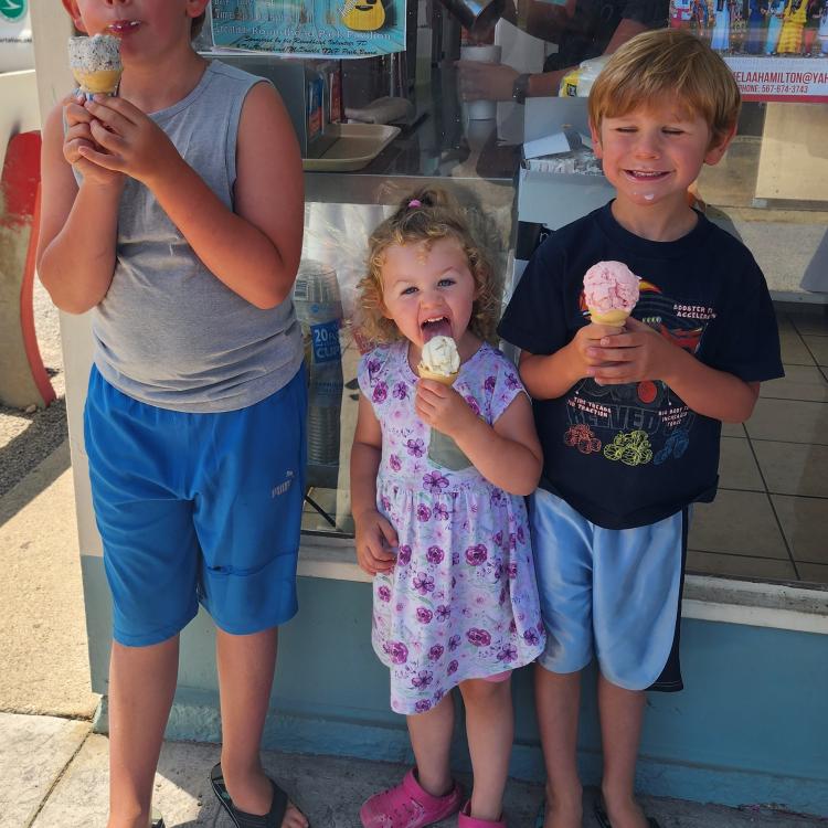 two boys and a little girl with ice cream cones