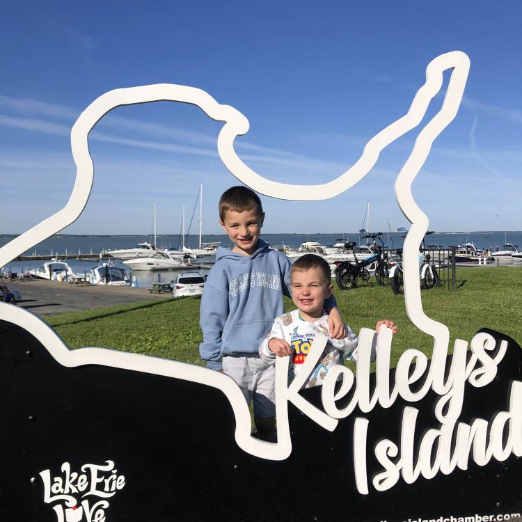 two little boys with Kelleys Island sign