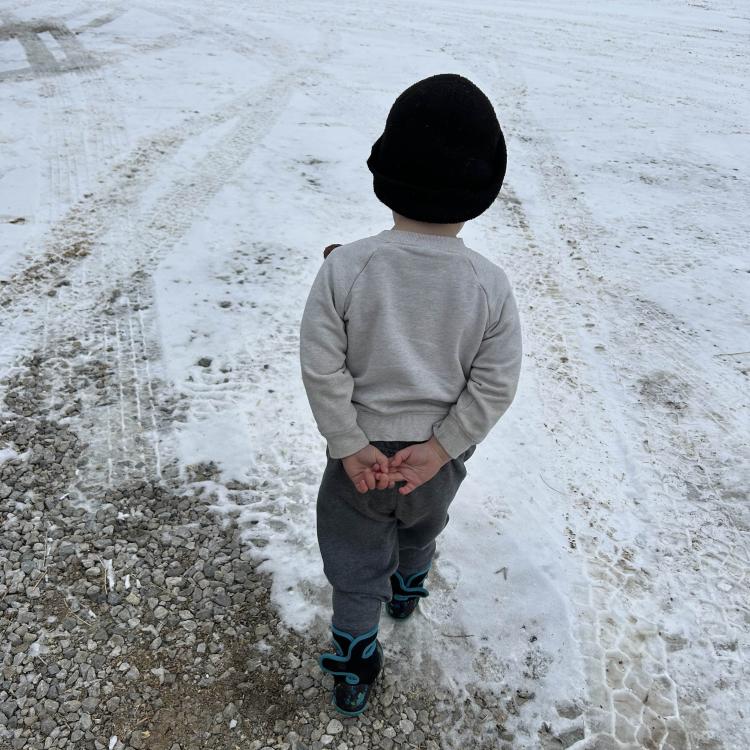 little boy walking on snow