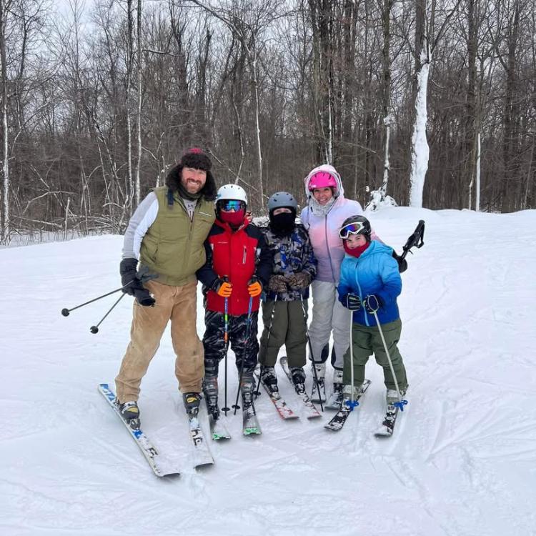 adults and children on skis