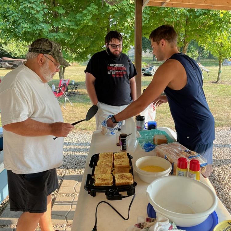 man cooking on outdoor griddle