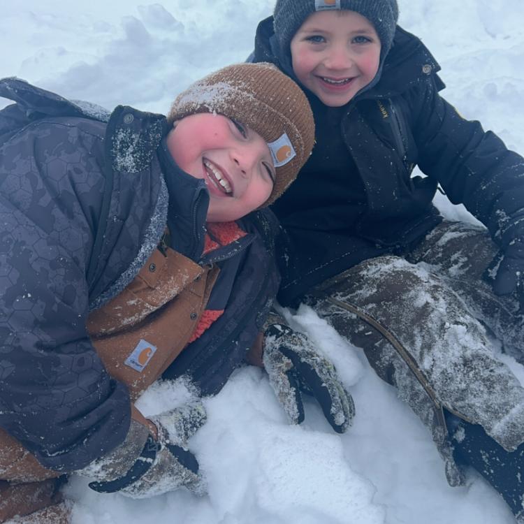 two smiling boys in snow