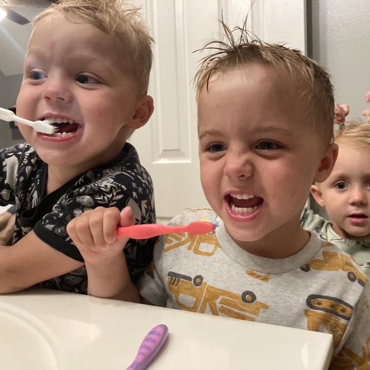 three little boys brushing their teeth