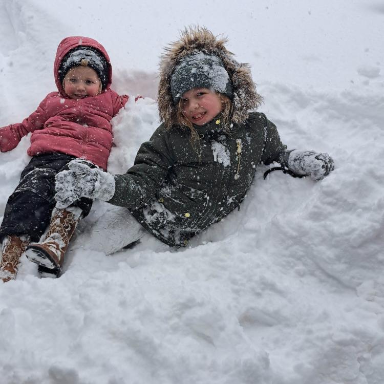 two smiling girls in the snow
