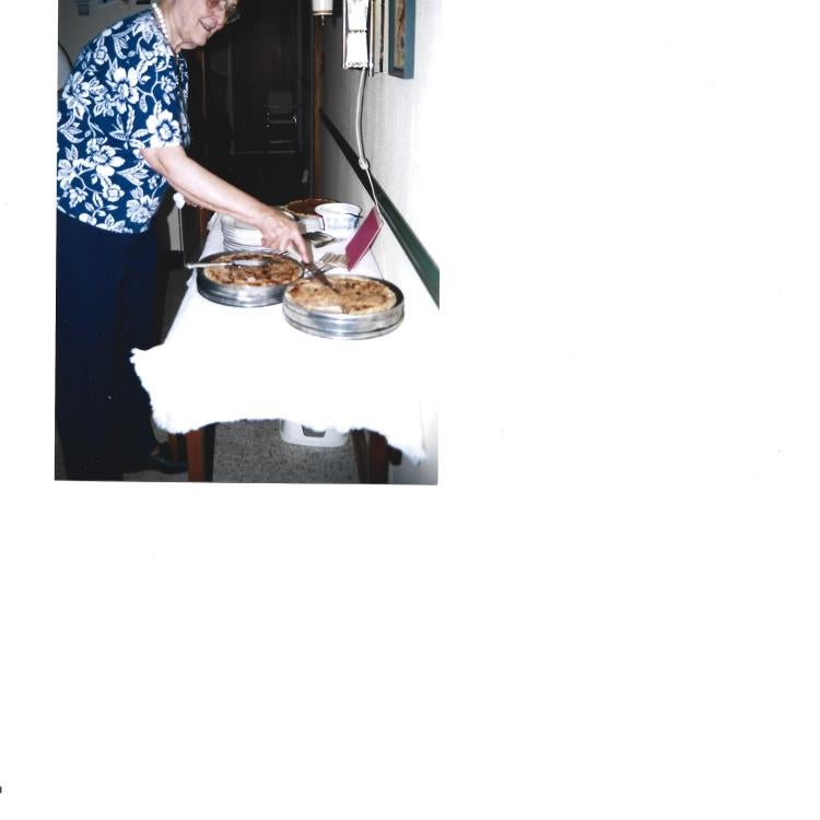 woman at table with pies