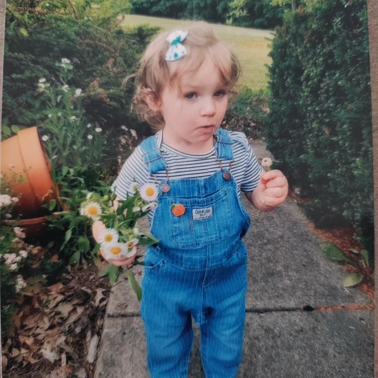 little girl holding flowers