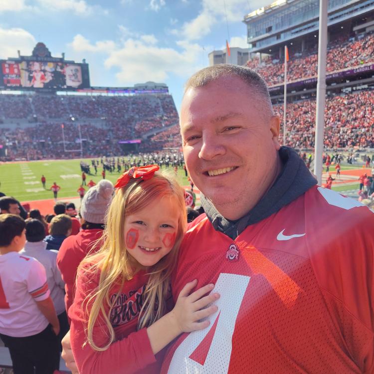 man and girl in football stadium