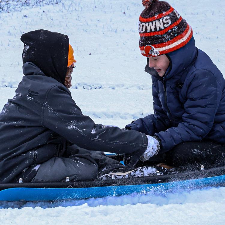 two kids on sled