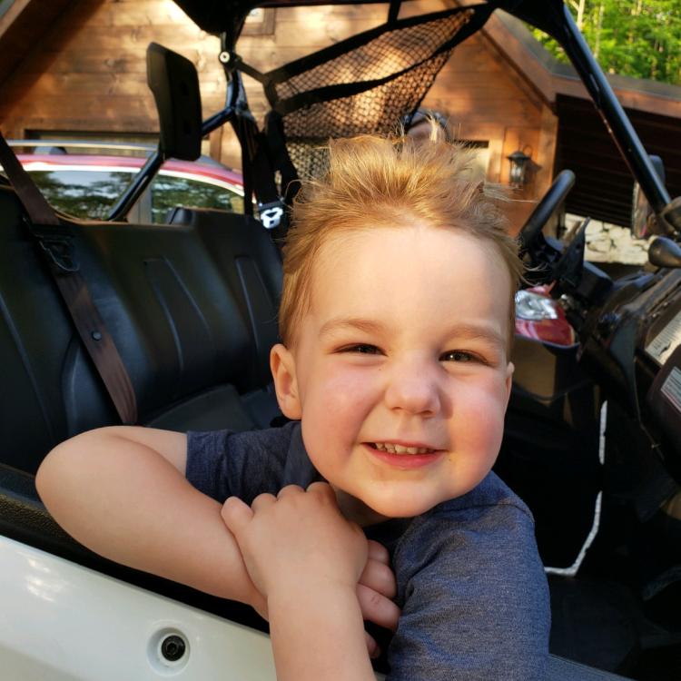 small boy with hair standing on end