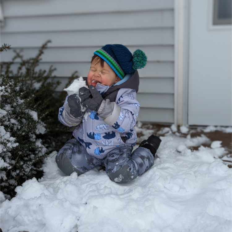 baby eating snow