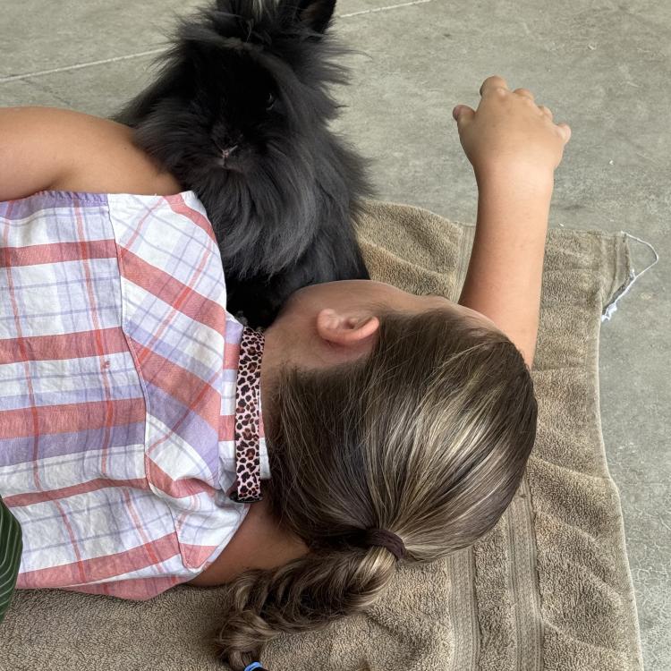 girl lying down with rabbit