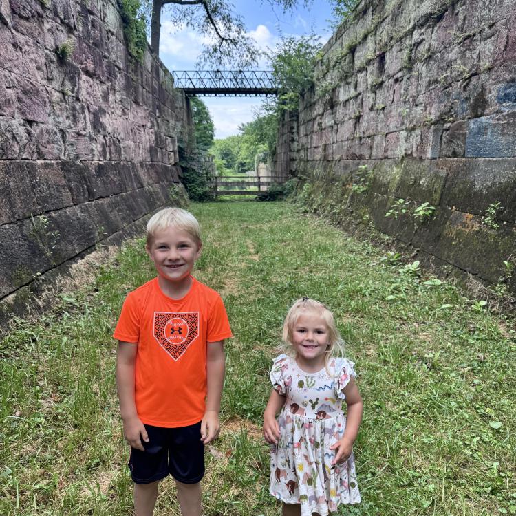 two children between stone walls