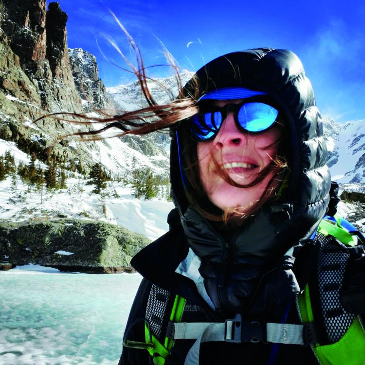 woman with snowy mountains in background