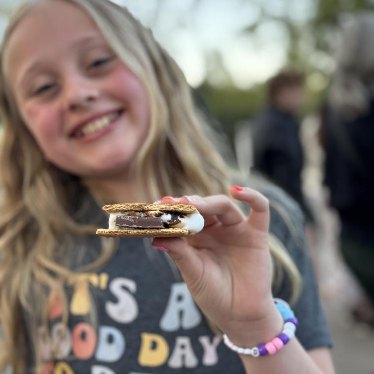 smiling girl holding s'more