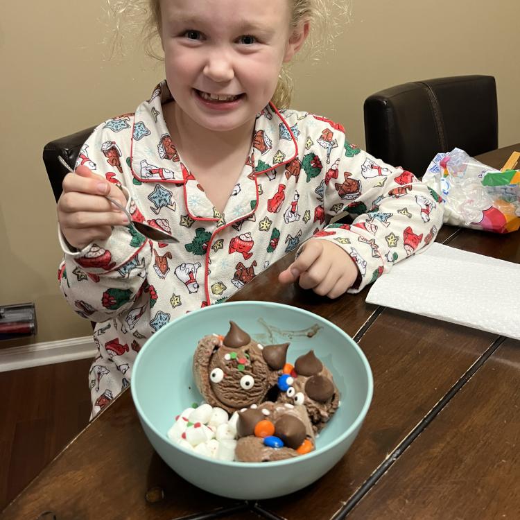 smiling girl with bowl of ice cream with candies