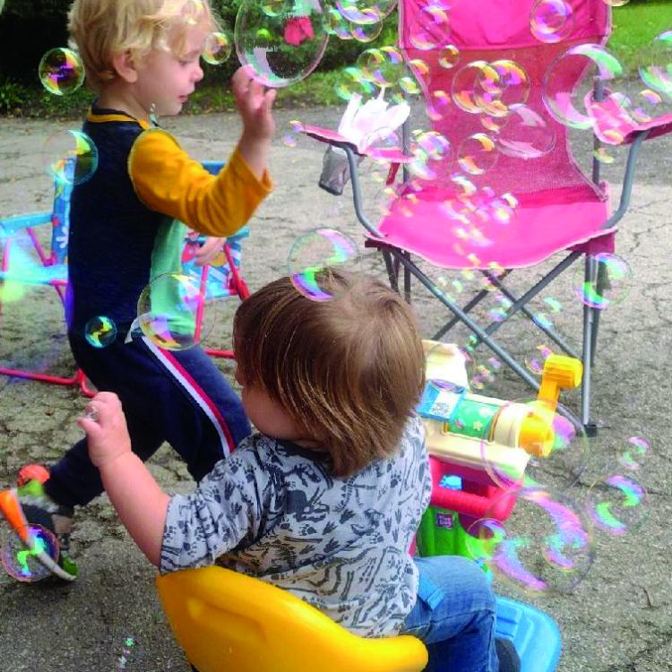 small child and baby surrounded by bubbles