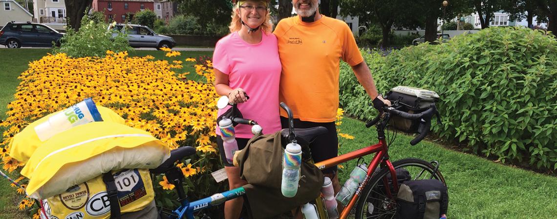 Karen and Bruce Beck pose with their tandem bicycle for a picture.