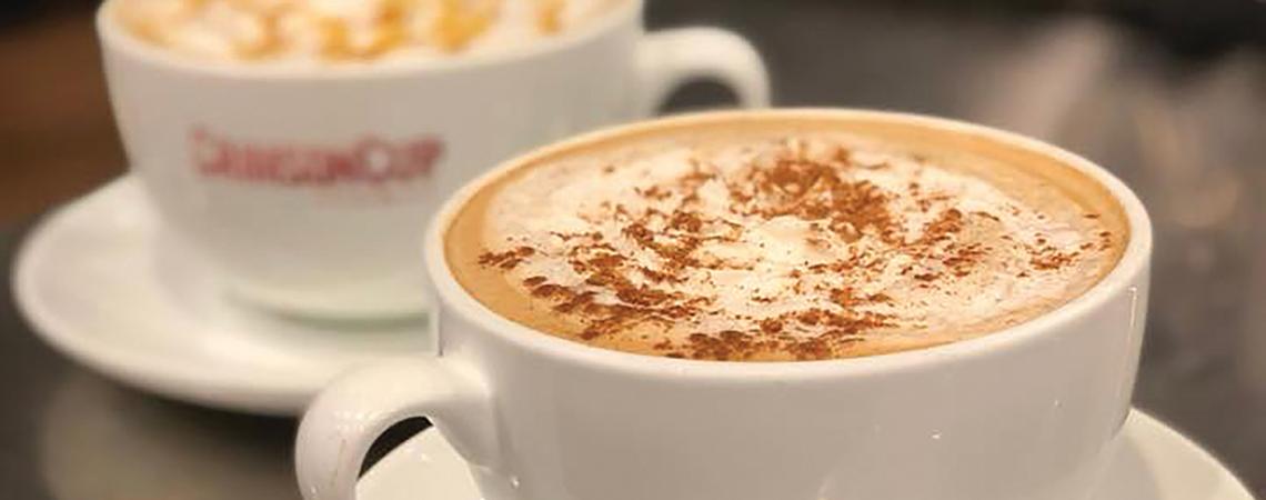 A cup of coffee with cinnamon.