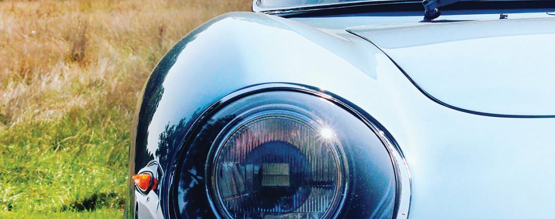 A close-up of an older car's headlight.