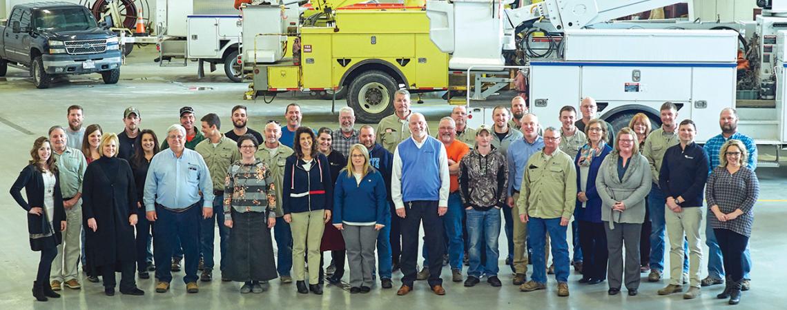 Employees of the cooperative smile for a group picture