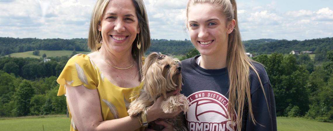 Teresa Harshbarger, her daughter Alexa and their puppy, Ashley, smile for a photo.