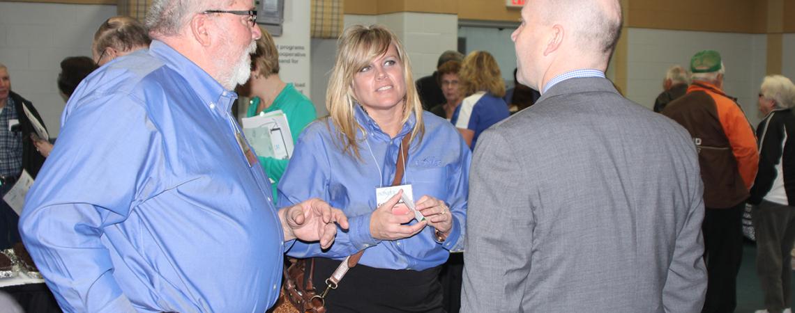 Colleen Eidemiller talks with two others.