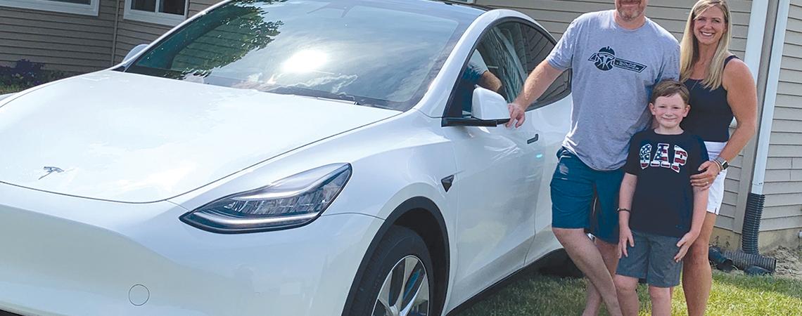 Huber family with their Tesla model Y
