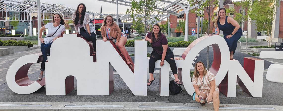 Posing with a Canton sign during a girls' trip with Canton Food Tours