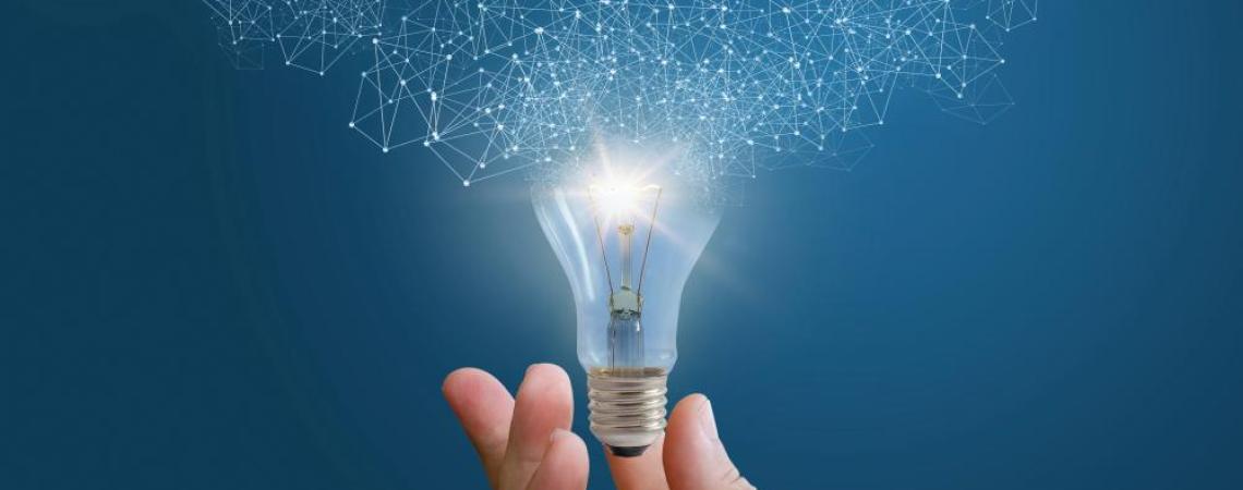 Hand holding lightbulb