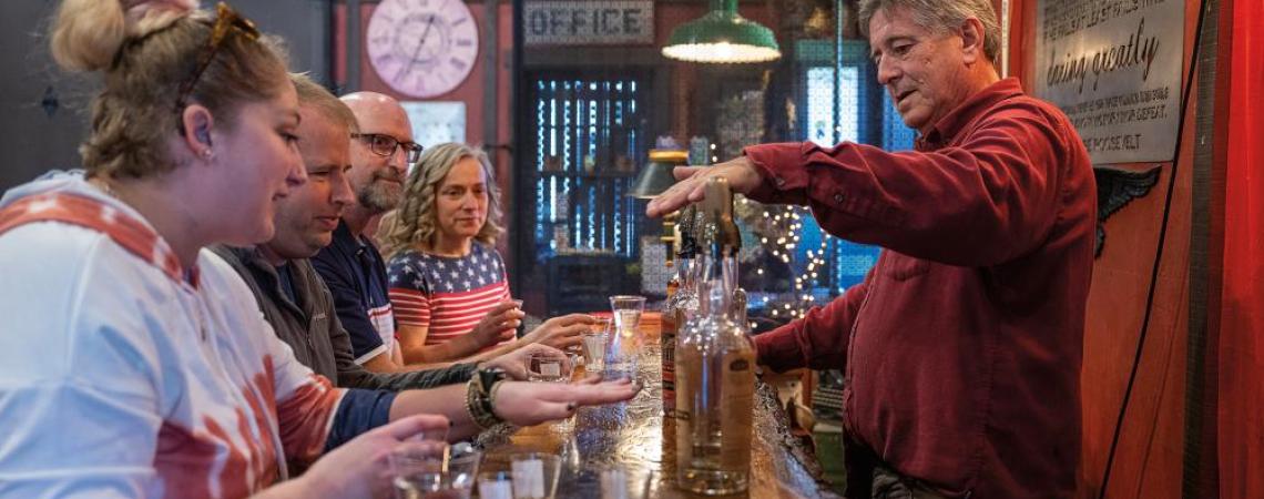 Visitors at Indian Creek Distillery cozy up to the bar for some samples.